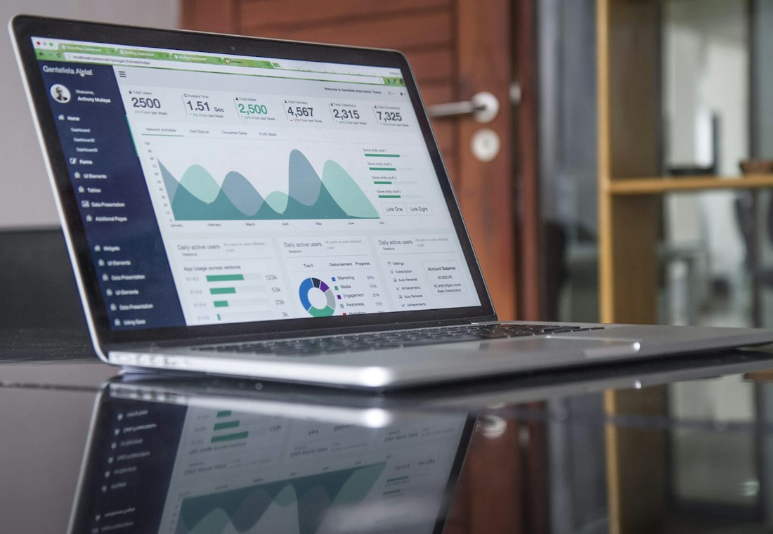 Laptop displaying business growth analytics and charts