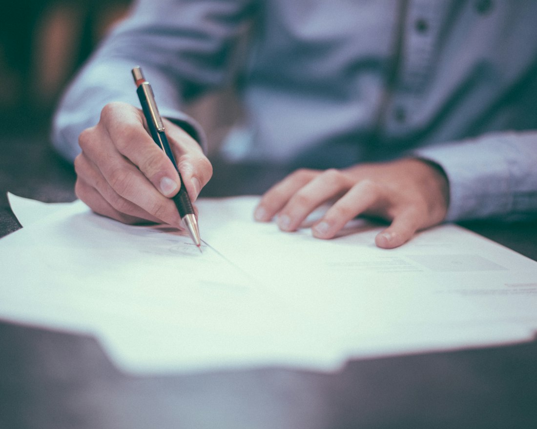Business owner signing funding paperwork