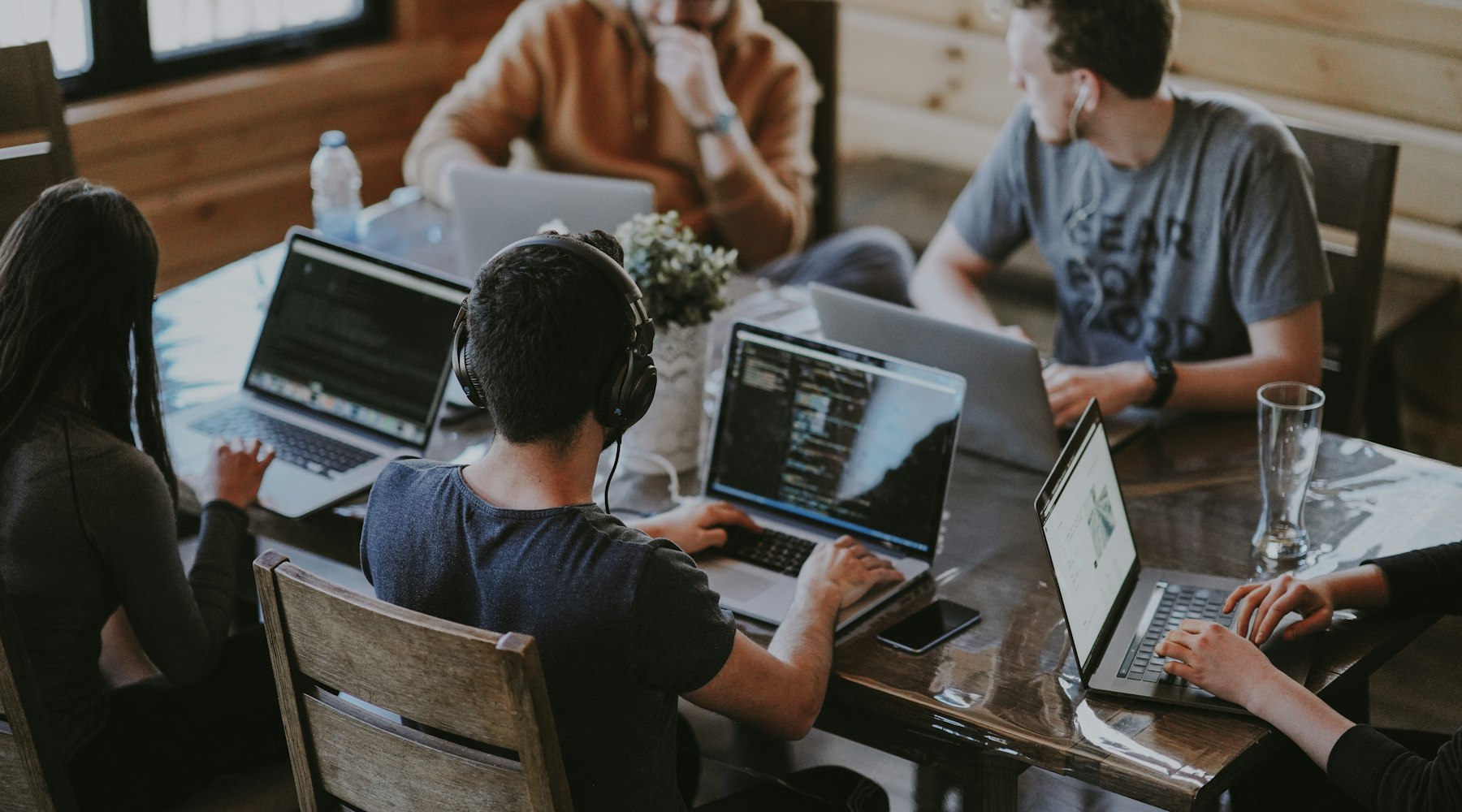 Team collaborating on laptops in a modern workspace